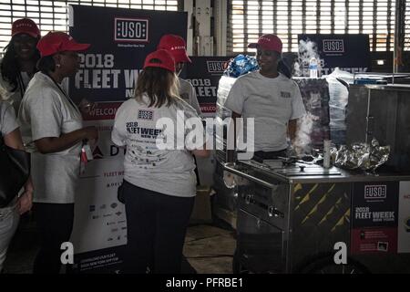 NEW YORK (May 25, 2018) United Service Organization volunteers prepare hot-dogs for Sailors and Marines for Fleet Week 2018. Now in its 30th year, Fleet Week New York is the city’s time-honored celebration of the sea services. It is an unparalleled opportunity for the citizens of New York and the surrounding tri-state area to meet Sailors, Marines and Coast Guardsmen, as well as witness firsthand the latest capabilities of today’s maritime services. Stock Photo