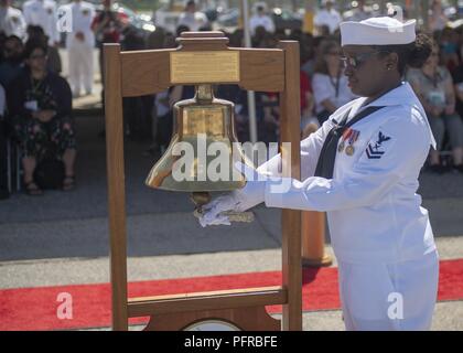 NORFOLK (May 26, 2018) Yeoman 2nd Class Rachel Skelton, whose father served aboard USS Scorpion (SSN 589) prior to the loss of the submarine, rings the bell during a Tolling of the Bellls for the Sailors during a memorial ceremony in honor of Scoprion Sailors who were lost at sea 50 years ago.  Held at the Scorpion Memorial on Naval Station Norfolk, the ceremony was attended by over 500 family members, friends and Shipmates of the 99 crewmembers lost.  Speakers for the event were Chief of Naval Operations, Admiral John Richardson; Captain (retired) Bill Richardson, CNO’s father and former Scor Stock Photo