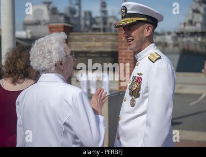 NORFOLK (May 26, 2018) Chief of Naval Operations (CNO) Adm. John Richardson talks with Ruthann Crowley, widow of Electronics Technician 1st Class Richard Hogeland, during a memorial ceremony in honor of USS Scoprion (SSN 589) Sailors who were lost at sea 50 years ago.  Held at the Scorpion Memorial on Naval Station Norfolk, the ceremony was attended by over 500 family members, friends and Shipmates of the 99 crewmembers lost.  Speakers for the event were Chief of Naval Operations, Admiral John Richardson; Captain (retired) Bill Richardson, CNO’s father and former Scorpion crewmember; Vice Admi Stock Photo