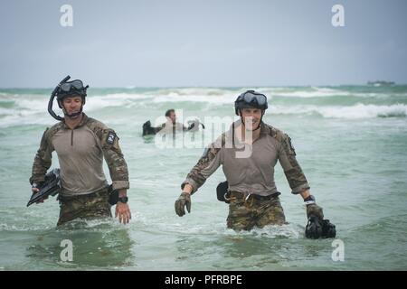 Air Force Reserve pararescuemen from the 920th Rescue Wing walk ashore after jumping out of a helicopter on May 26th, 2018 during the 2nd annual Salute to American Heroes Air and Sea Show, in Miami Beach. This two-day event showcases military fighter jets and other aircraft and equipment from all branches of the United States military in observance of Memorial Day, honoring servicemembers who have made the ultimate sacrifice. Stock Photo