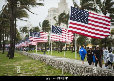 American flags are displayed along Miami Beach, Florda on May 26th, 2018, during the 2nd annual Salute to American Heroes Air and Sea Show. This two-day event showcases military fighter jets and other aircraft and equipment from all branches of the United States military in observance of Memorial Day, honoring servicemembers who have made the ultimate sacrifice. Stock Photo