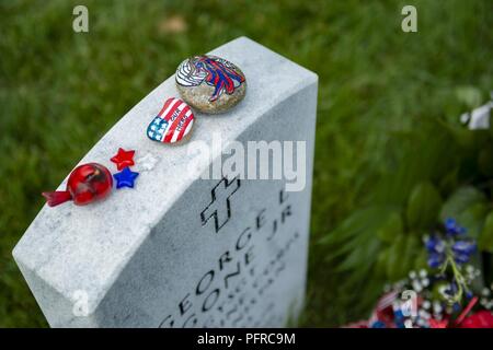 Flags, flowers and other mementos adorn headstones in Section 60 of Arlington National Cemetery, Arlington, Virginia, May 27, 2018. Every year over Memorial Day weekend, over 135,000 visitors come to Arlington National Cemetery to honor those who have died while in the armed forces. Stock Photo