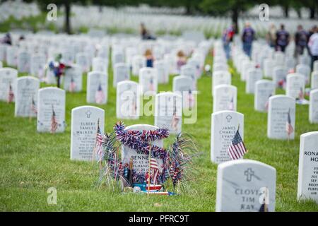 Flags, flowers and other mementos adorn headstones in Section 60 of Arlington National Cemetery, Arlington, Virginia, May 27, 2018. Every year over Memorial Day weekend, over 135,000 visitors come to Arlington National Cemetery to honor those who have died while in the armed forces. Stock Photo