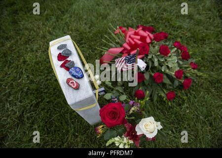 Flags, flowers and other mementos adorn headstones in Section 60 of Arlington National Cemetery, Arlington, Virginia, May 28, 2018. Every year over Memorial Day weekend, over 135,000 visitors come to Arlington National Cemetery to honor those who have died while in the armed forces. Stock Photo