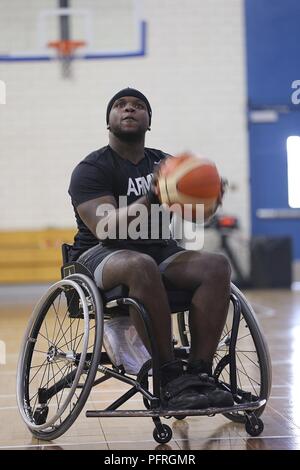 U.S. Army Sgt. Cory Ivins, a participant in the DoD Warrior Games, free throws during wheelchair basketball practice, Colorado Springs, Colorado, May 29, 2018. The DoD Warrior Games is an adaptive sports competition for wounded, ill, and injured service members and veterans. Approximately 300 athletes representing teams from the Army, Marine Corps, Navy, Air Force, Special Operations Command, United Kingdom Armed Forces, Canadian Armed Forces, and the Australian Defence Force will compete June 1 - June 9 in archery, cycling, track, field, shooting, sitting volleyball, swimming, wheelchair bask Stock Photo