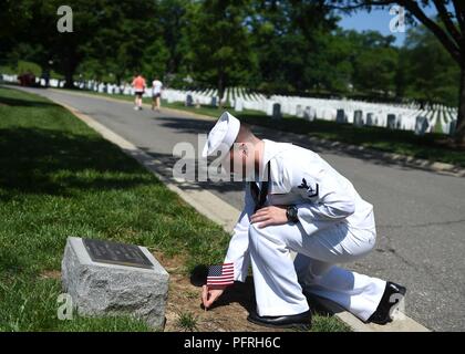 Va. (May 25, 2018) Yeoman 3rd Class Robert Petrovic, assigned to Naval History and Heritage Command, places a flag at the USS Houston (CA-30) and HMAS Perth marker at Arlington National Cemetery to honor the fallen heroes in observance of Memorial Day. USS Houston and HMAS Perth were sunk during the Battle of Sunda Strait on March 1, 1942 against the Imperial Japanese Navy. Stock Photo