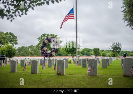 FORT BENNING, Ga. (May 30, 2018) – Soldiers, veterans and civilians attend the Fort Benning Memorial Day Ceremony May 28, 2018 at the Main Post Cemetery. Maj. Gen. Gary M. Brito, commanding general of Maneuver Center of Excellence Fort Benning, and MCoE and Fort Benning Command Sgt. Maj. Scott A. Brzak laid the ceremonial wreath. Stock Photo