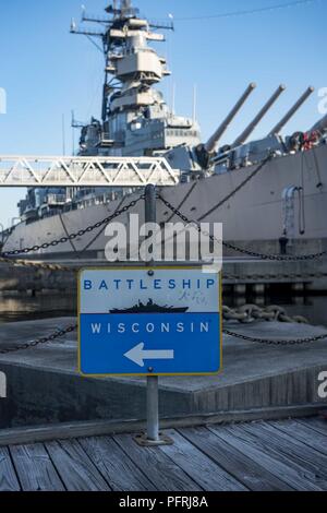 NORFOLK, Va. (May 24, 2018) The decommissioned battleship USS Wisconsin (BB 64) sits moored near downtown Norfolk. Sailors from the aircraft carrier USS George H.W. Bush (CVN 77) volunteered aboard Wisconsin as a part of the CPO 365 program. Stock Photo