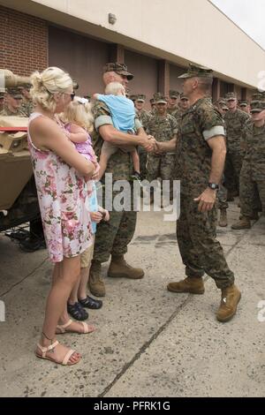 U.S. Marine Corps Maj. Gen. John K. Love, commanding general, 2nd Marine Division, congratulates Gunnery Sgt. Matthew R. Hendges, with 2nd Tank Battalion, for his accomplishments during the 2018 Sullivan Cup competition, on Camp Lejeune, N.C., May 30, 2018. The Sullivan Cup competition is held to determine the best tank crew throughout the different branches of the military. Stock Photo