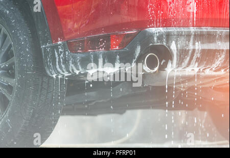 Red compact SUV car with sport and modern design washing with soap. Car  covered with white foam. Car care service business concept. Car wash with  foam Stock Photo - Alamy