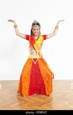 Teenage girl performing Bollywood dance move, influenced by Arabic dances Stock Photo