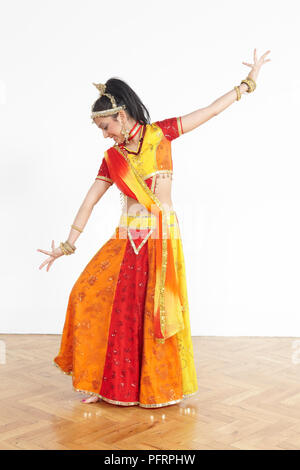 Teenage girl performing Bollywood dance moves, based on Arabic dances ...