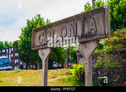 Colonia old train sign with a tourism bus in the background Stock Photo