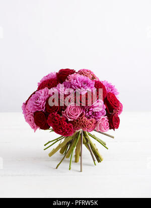 Pink and red hand tie bouquet, red celosia, pink celosia, pink dahlia, pink acqua rose, red 'Grand Prix' rose Stock Photo
