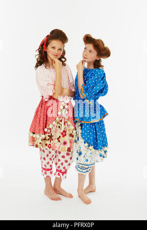 Two girls dressed as Cinderella's sisters in blue and pink fancy dress costume Stock Photo