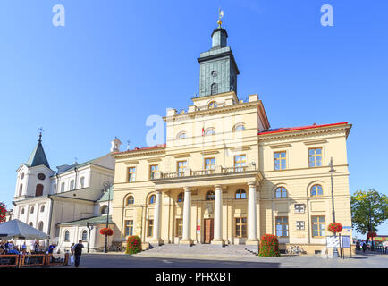 New Town Hall in Lublin, built between 1827-1828 in the classical style. Next on the left visible Church of the Holy Spirit Stock Photo