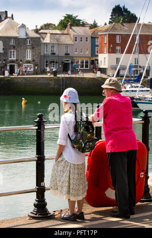 UK, Cornwall, Padstow, North Quay, senior couple in sun protection clothing at quayside Stock Photo