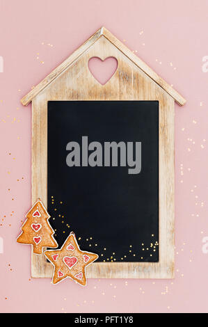 Christmas chalkboard, with star and Christmas tree decorations and golden star-shaped glitter. Vintage style. Top view. With space for text. Stock Photo