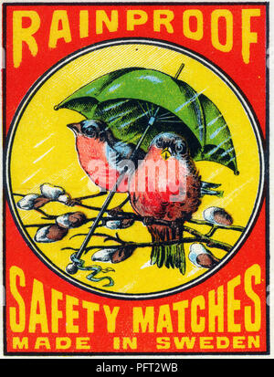 Antique safety matches. The label of this antique matchbox label shows two birds sitting under an umbrella to avoid the rain. The text says Rainproof safety matches. Made in Sweden. Stock Photo