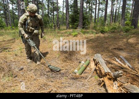 U.S. Army Sgt. Steve Maher, 707th Explosive Ordnance Disposal technician,  out of Fort Lewis, Wash., builds C-4 explosive charges being used to  destroy the Taliban Hotel, a safehouse utilized by insurgent fighters