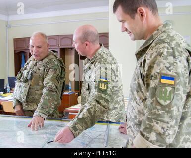 Yavoriv, Ukraine – Maj. Gen. Raymond Shields, commander of the New York Army National Guard meets with Ukrainian officers during a visit to the Yavoriv Combat Training Center here May 25. During his visit Shields met with JMTG-U leaders and awarded challenge coins to U.S. service members to recognize them for their hard work. Stock Photo