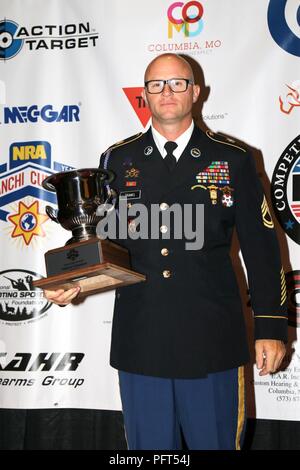 U.S. Army Sgt. 1st Class Patrick Franks from Las Vegas, Nevada accepts his 2018 Bianchi Cup Production Division Champion trophy in Columbia, Missouri May 25 after competing in the three-day competition that drew over 170 competitors from eight countries. Franks, a member of the U.S. Army Marksmanship Unit’s Service Pistol Team, also seized the 2018 World Action Pistol Championships’ Production Division Champion title on May 20. Stock Photo