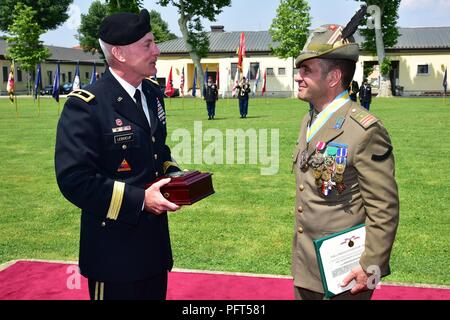 The outgoing Italian Base Command Sgt. Maj. Antonio Quaglia (right), receives a gift from Brig. Gen. Eugene J. LeBoeuf, acting Commander of U.S. Army Africa (left), during the Italian Base Command Change of Responsibility at Caserma Ederle in Vicenza, Italy, May 31, 2018.