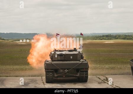 An Austrian Leopard 2A4 tank fires at its target during the calibration range during Strong Europe Best Tank.  U.S. Army Europe and the German Army co-host the third Strong Europe Tank Challenge at Grafenwoehr Training Area, June 3 - 8, 2018. The Strong Europe Tank Challenge is an annual training event designed to give participating nations a dynamic, productive and fun environment in which to foster military partnerships, form Soldier-level relationships, and share tactics, techniques and procedures. ( U.S. Army Stock Photo