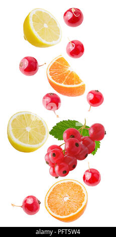 Isolated flying citrus fruits. Falling orange, lemon and red currant isolated on white background with clipping path as package design element and adv Stock Photo