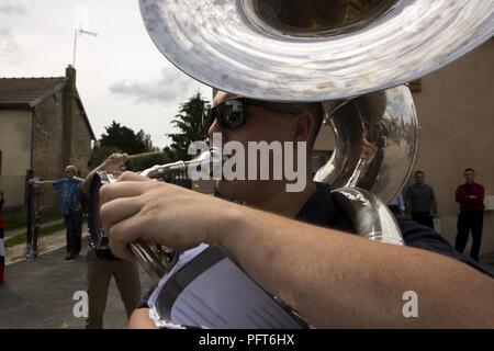 U.S. Marine Corps Cpl. Austin Cornella with the 2d Marine Division Band, 2d MARDIV, plays his sousaphone during a live performance at the 1775 Cafe de la place after the memorial ceremony of the Battle of Belleau Wood in Belleau, France on May 27, 2018. Sixth Marines is conducting bi-lateral training with the 6th Light Armored Brigade, in junction to honor the 100th anniversary of the Battle of Belleau Wood. Stock Photo