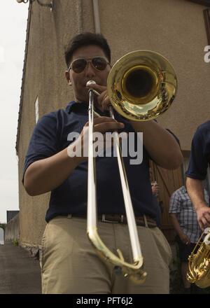 U.S. Marine Corps Cpl. Jason Hu with the 2d Marine Division Band, 2d MARDIV, plays his trombone during a live performance at the 1775 Cafe de la place after the memorial ceremony of the Battle of Belleau Wood in Belleau, France on May 27, 2018. Sixth Marines is conducting bi-lateral training with the 6th Light Armored Brigade, in junction to honor the 100th anniversary of the Battle of Belleau Wood. Stock Photo