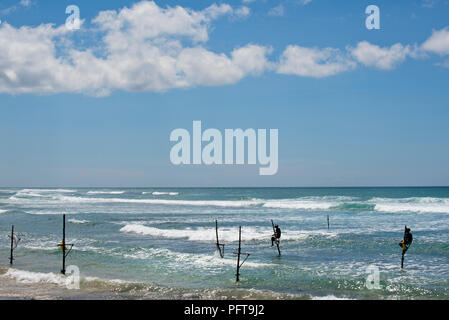 Sri Lanka, Southern Province, Midigama, stilt fishermen fishing in sea Stock Photo