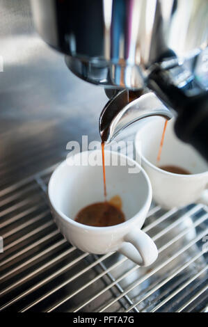 Coffee pouring from an espresso machine Stock Photo