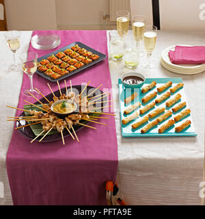 Finger food buffet, chicken satays, salmon on rye, duck and hoisin spring rolls Stock Photo