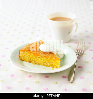 Orange polenta cake and cup of tea Stock Photo