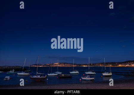 Small boats at night in Rhos-on-Sea harbour on the North Wales coast Stock Photo