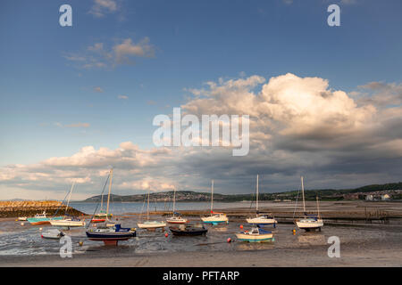 Small boats at low tide in Rhos-on-Sea harbour on the North Wales coast Stock Photo