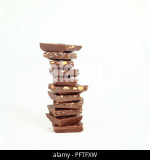 high stack of slices of original milk chocolate .isolated on whi Stock Photo