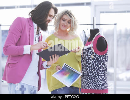 Two fashion designers discuss the color of the new clothing collection Stock Photo