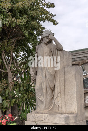 Sculpture of mourning woman in the Poblenou Cemetery. Cemetery of Poblenou is today home to incredible sculptures, haunting, yet beautiful. Stock Photo