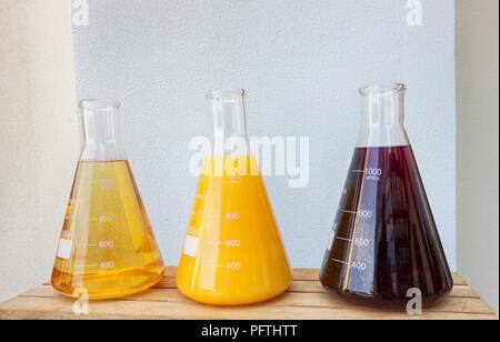 Glass Conical Erlenmeyer Flask filled with fruit juices. Vitamin concept.Solution of vitamin in laboratory flasks. Health and Beauty Stock Photo