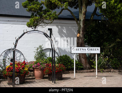 Gretna Green, United Kingdom - August 08 2018:   A metal archway decorated with horseshoes for good luck, used by couples getting married at Gretna Gr Stock Photo