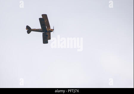 Pangbourne, United Kingdom - June 10 2018:   de Haviland Tiger moth biplane, registration DF-128, flies overhead on a grey day Stock Photo