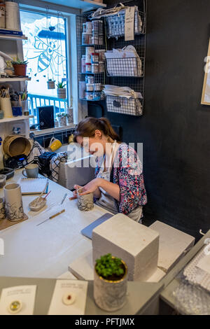 A young lady working in her workshop making ceramic jugs Stock Photo