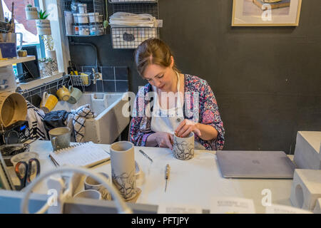A young lady working in her workshop making ceramic jugs Stock Photo