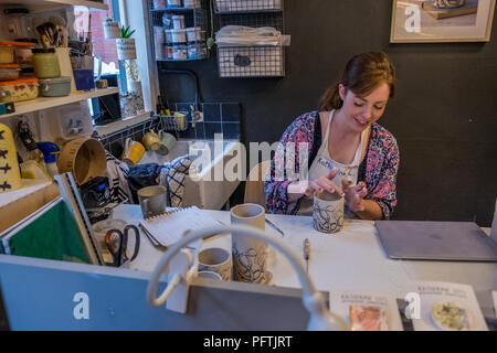 A young lady working in her workshop making ceramic jugs Stock Photo