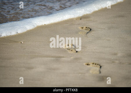 Detail shot with man footprints in the sand on a beach Stock Photo - Alamy