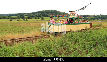 Seaton Tramway passing through Colyford Common part of Seaton Wetlands Nature Reserve Stock Photo