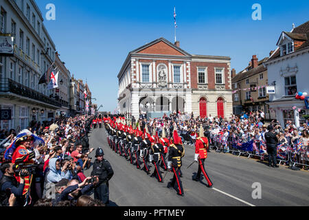 Members of the Household Cavalry Life Guards (red tunics) and Blues & Royals (blue tunics) march through Windsor before the Royal Wedding Stock Photo