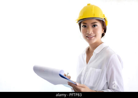 Asian women engineering inspecting and working and holding blueprints at office Stock Photo